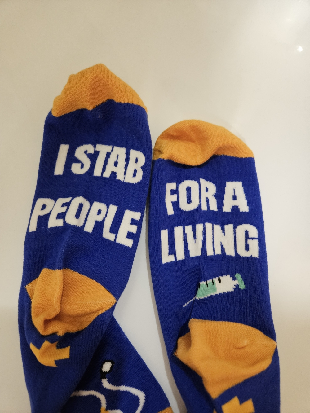 Novelty 'I Stab People For A Living' Blue & Orange Crew Socks